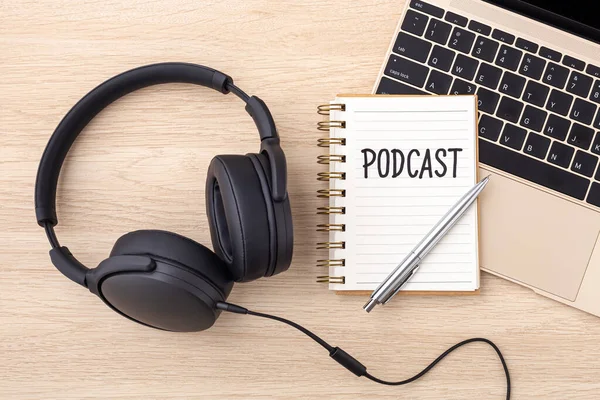 Headphones beside a notebook on top of a laptop for Copywriting For Coaches